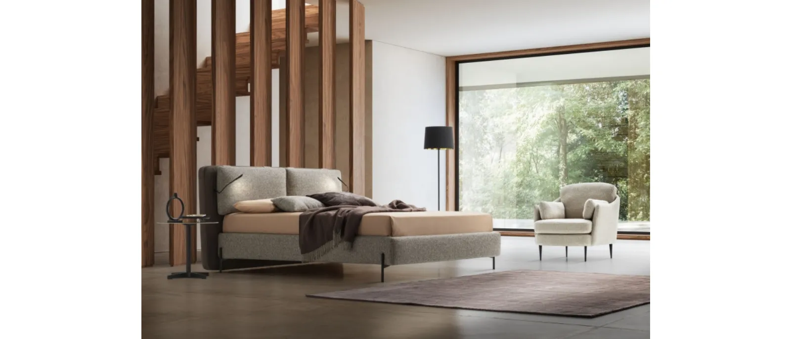 Bed with a padded upholstered headboard made of fabric from the collection Cortina by Le Comfort.