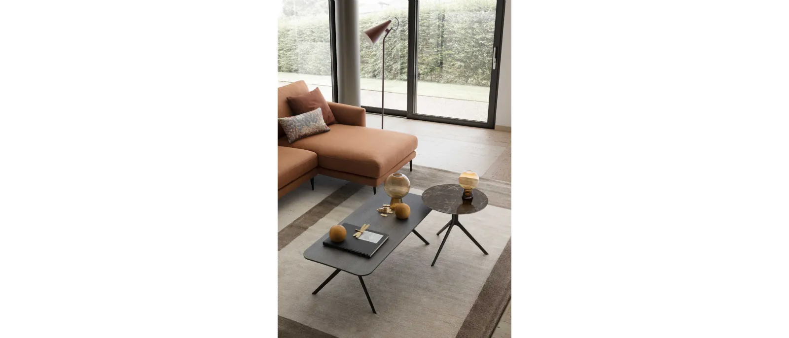 Silky coffee table by LeComfort features a rectangular oak top with grey wash finish and the legs