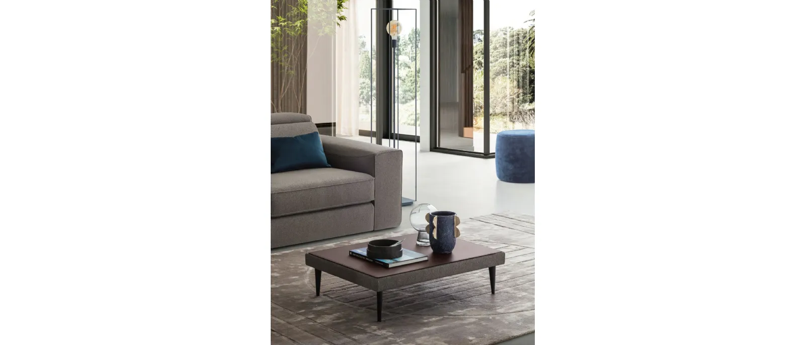 LeComfort presents its new model of small table covered with fabric and tray made with leather or textile covering the top part