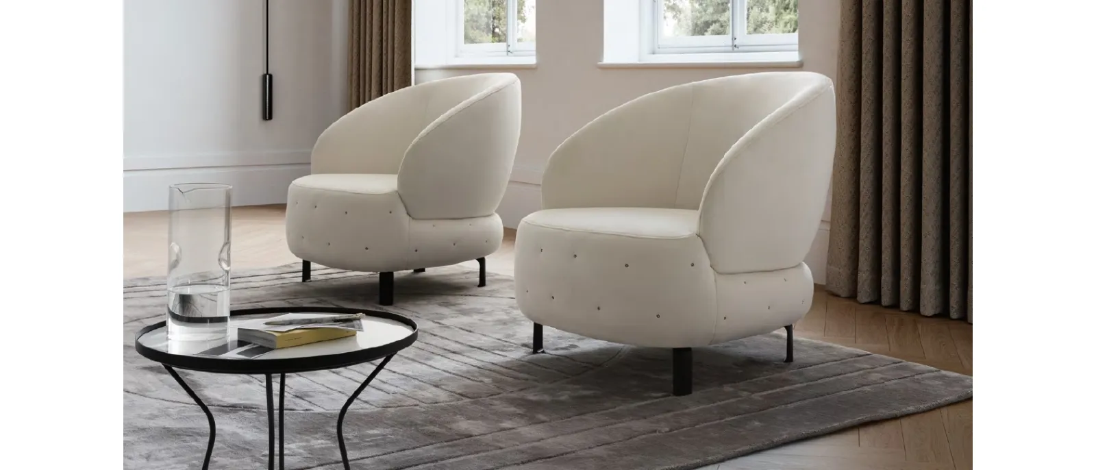 A modern armchair upholstered with a fabric soft to the touch and very light