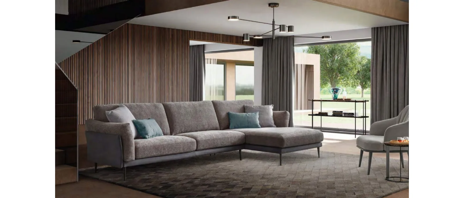 The fabric sofa with penisola is part of the collection composed by modular pieces designed for