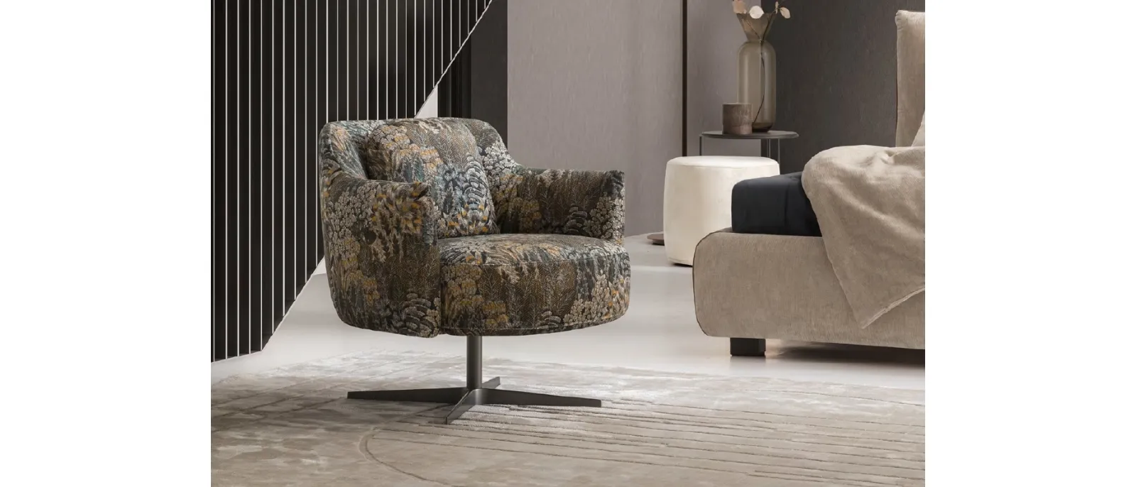 Shelley armchair from Le Comfort is covered with fabric printed on both sides which shows a large print of leaves